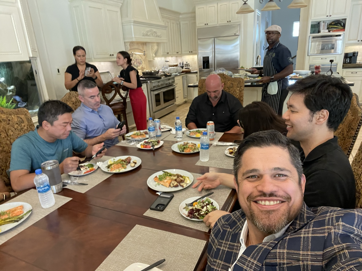 Romulo sharing a meal and conversation around a table with friends and colleagues